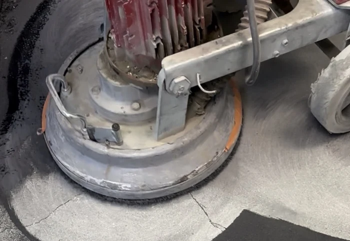 Concrete grinder preparing a Nampa garage floor coating