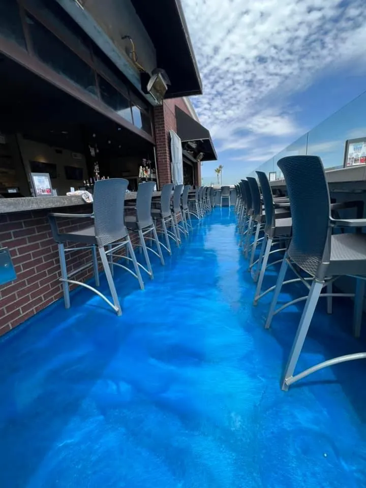 Blue metallic epoxy floor coating on a commercial patio by Epoxy Pros