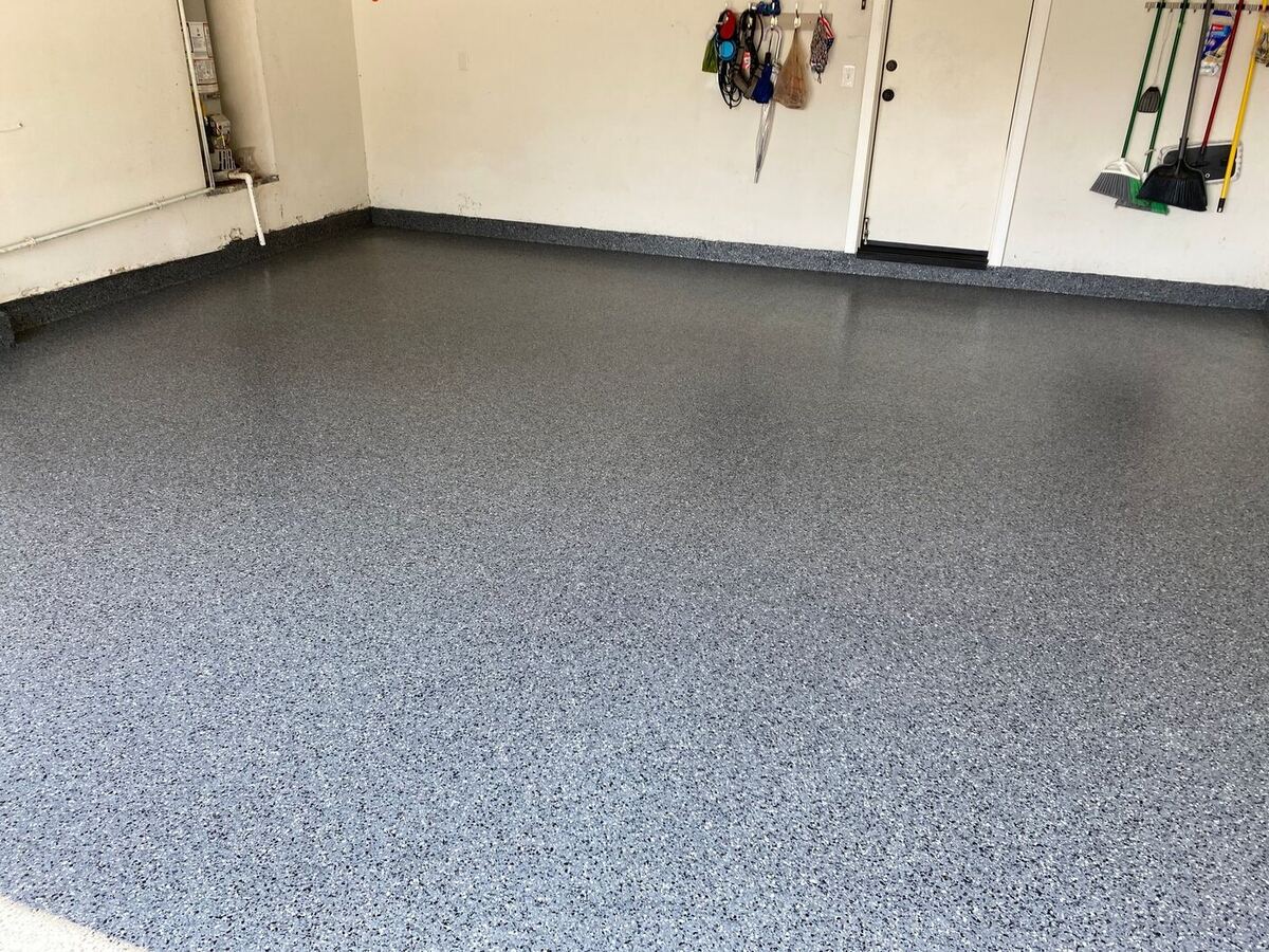 Finished epoxy garage floor with gray flake coating