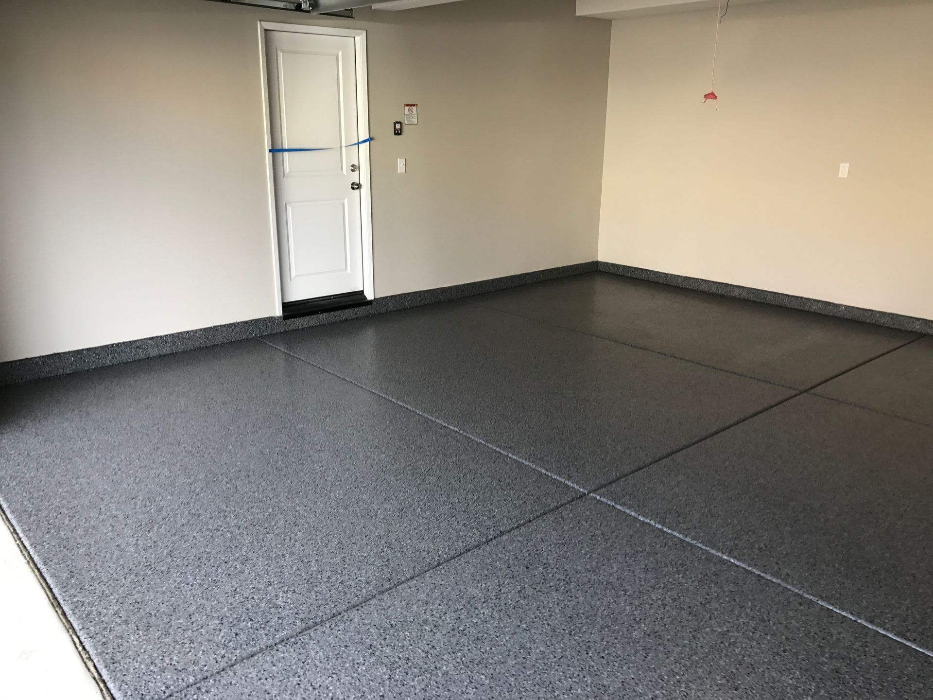 Close view of a gray flake epoxy garage floor