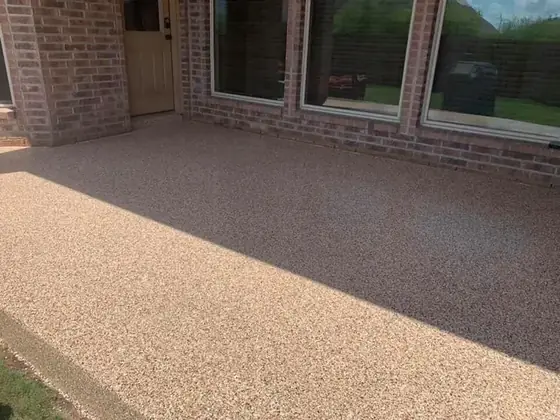 Tan decorative flake concrete coating on a patio